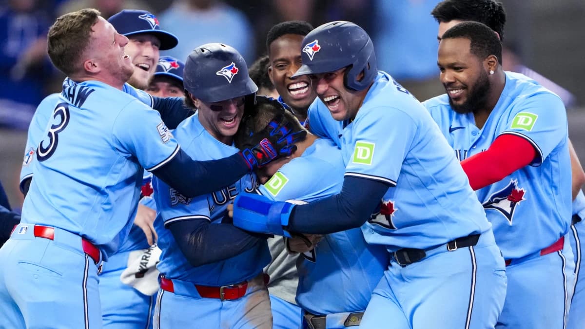 Toronto Blue Jays center fielder Daulton Varsho (5) celebrates hitting a grand slam walk off to defeat the Tampa Bay Rays during the tenth inning with teammates at Rogers Centre.