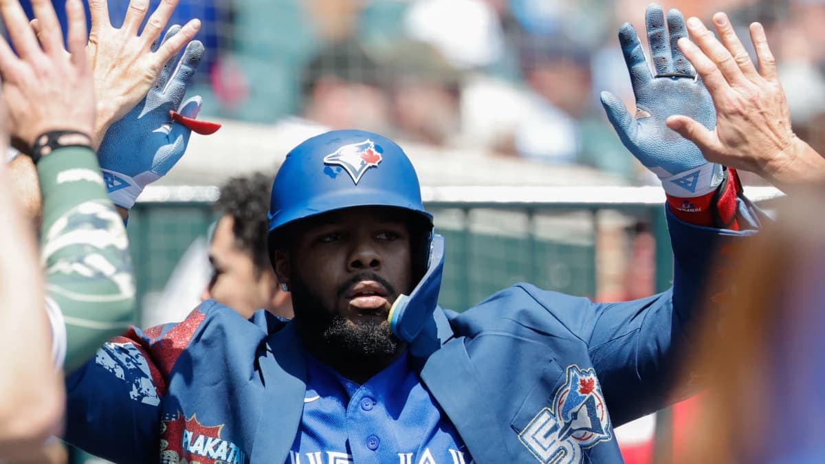 Toronto Blue Jays first baseman Vladimir Guerrero Jr. (27) receives congratulations from teammates after he hits a home run in the first inning against the Detroit Tigers at Comerica Park.