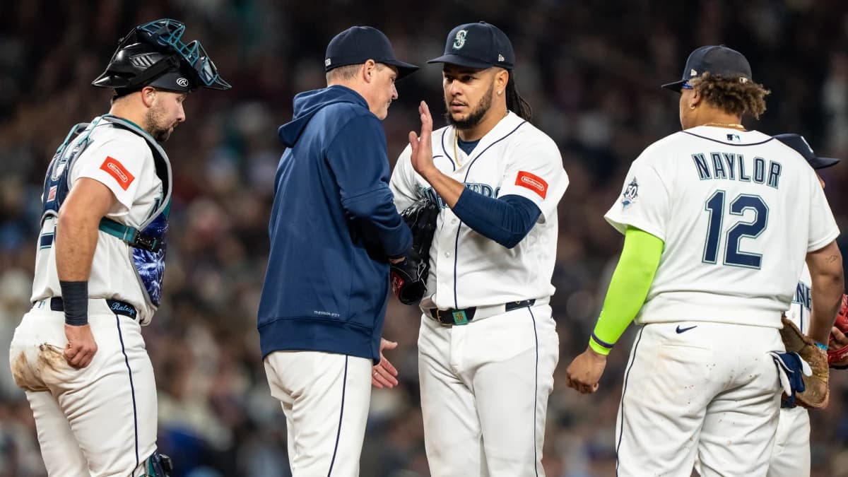 Seattle Mariners manager Dan Wilson, second from left, pulls starting pitcher Luis Castillo (58) from the game during a meeting at mound with catcher Cal Raleigh (29) and first baseman Josh Naylor (12)in the fourth inning against the Houston Astros at T-Mobile Park.