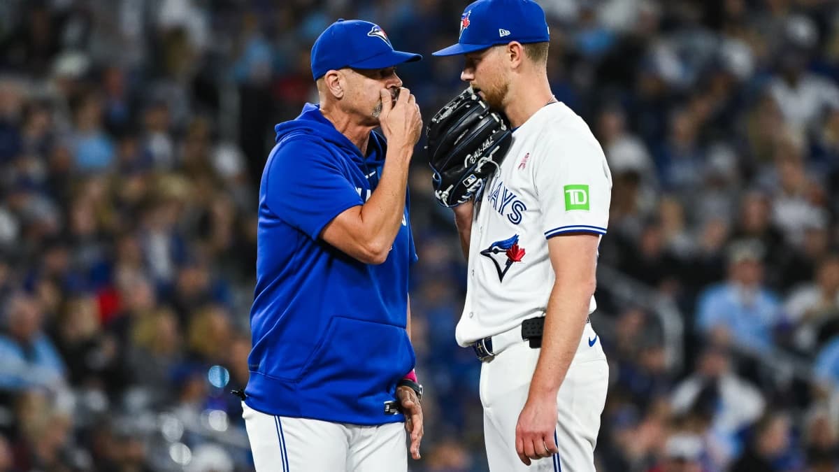 Toronto Blue Jays starting pitcher Eric Lauer (56) has a discussion with pitching coach Pete Walker (40) against the Los Angeles Angels in the fifth inning at Rogers Centre.