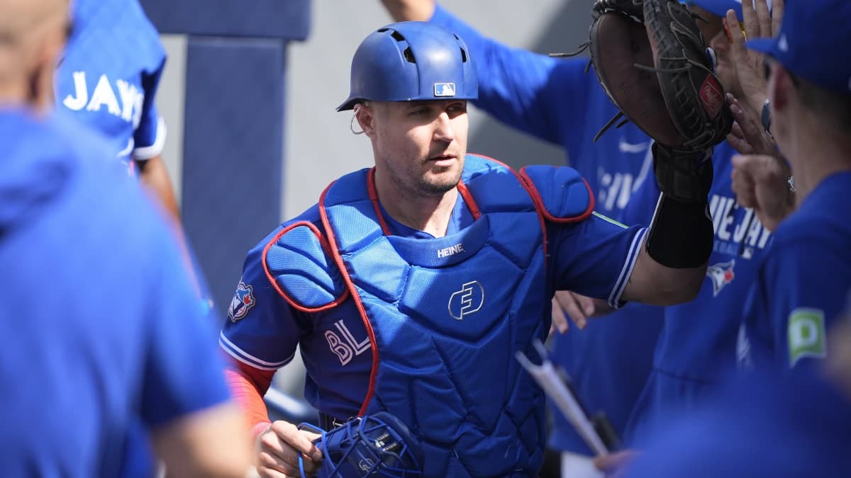 Toronto Blue Jays catcher Tyler Heineman (55) gets congratulated in the dugout after throwing out Miami Marlins center fielder Jakob Marsee (not pictured) at second base during the eighth inning at Rogers Centre.