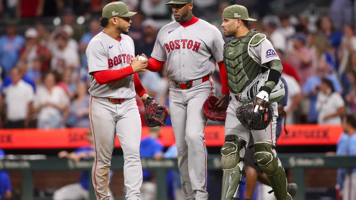 Boston Red Sox first baseman Willson Contreras (40) and pitcher Aroldis Chapman (44) and catcher Carlos Narvaez (75) celebrate after a victory over the Atlanta Braves at Truist Park.