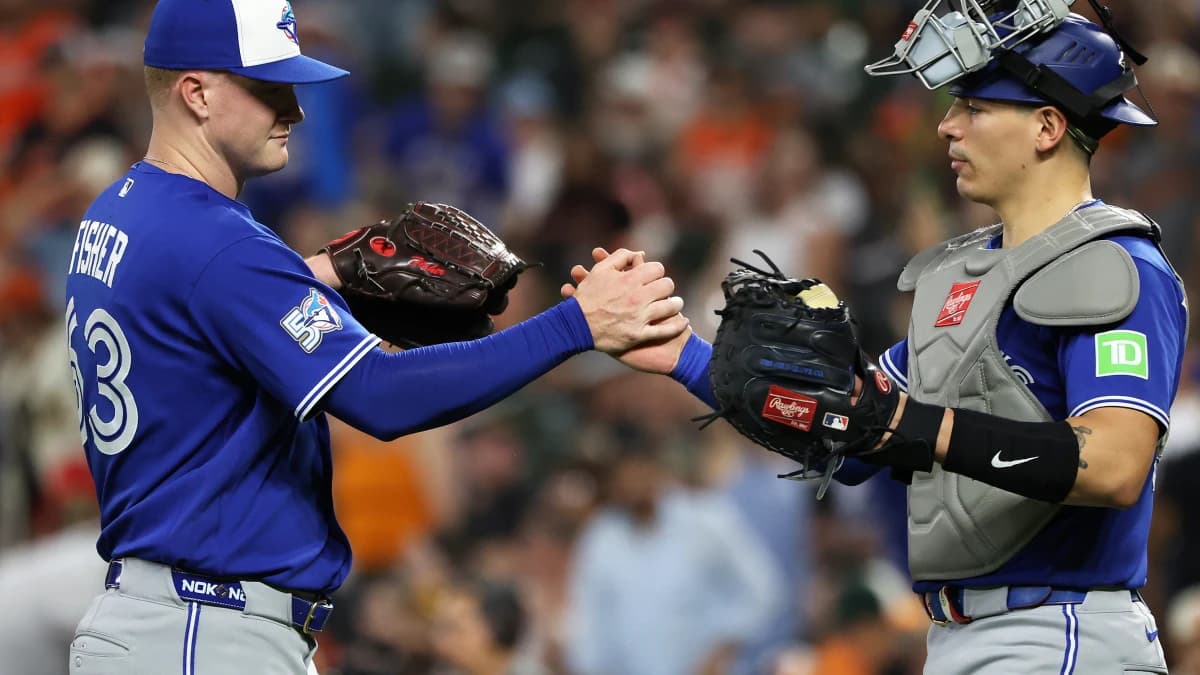 Toronto Blue Jays pitcher Braydon Fisher (63) celebrates with Toronto Blue Jays catcher Brandon Valenzuela (59) after a game against the Baltimore Orioles at Oriole Park at Camden Yards.