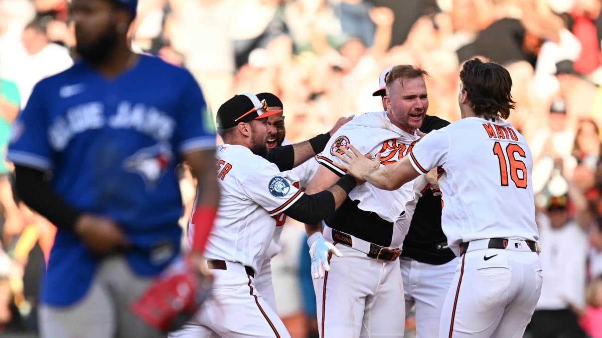Teammates surround Baltimore Orioles infielder Pete Alonso (25) after Alonso hit a walk-off single in the ninth inning against the Toronto Blue Jays at Oriole Park at Camden Yards.