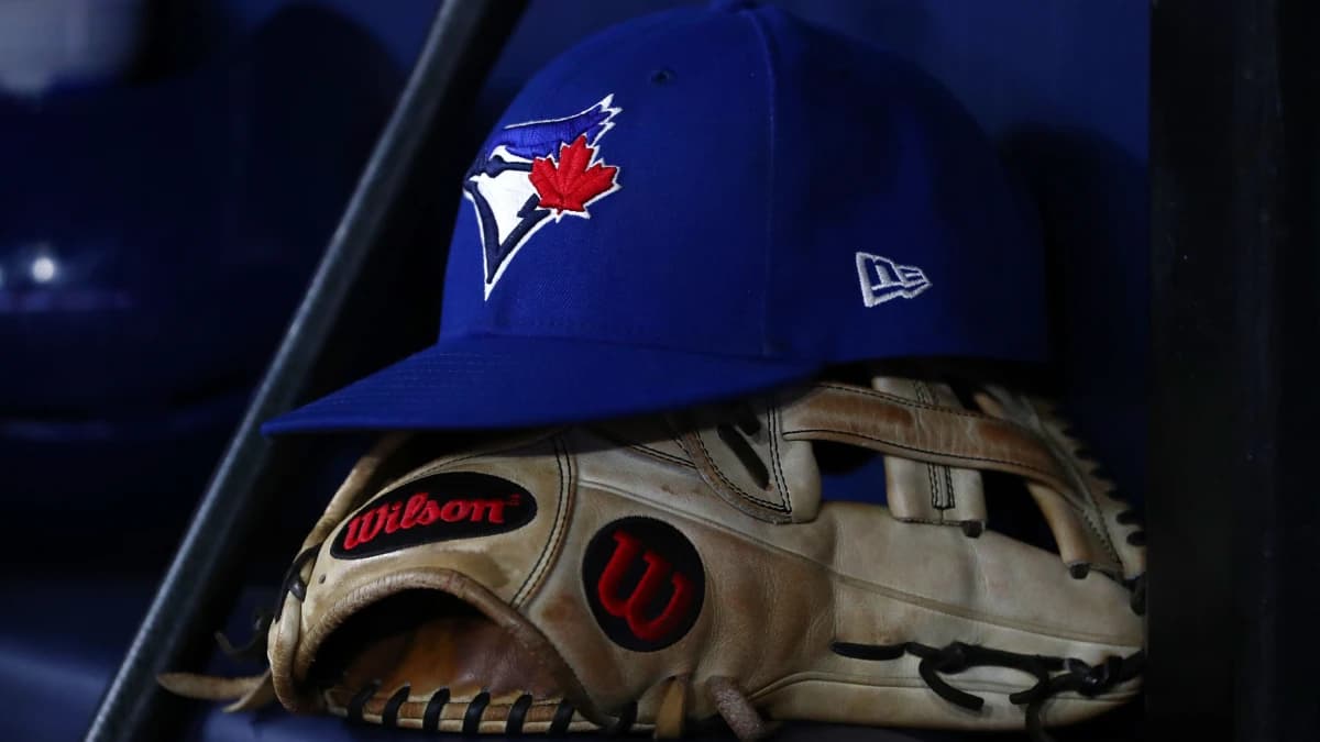 A detail view of a Tampa Bay Rays hat and glove lay in the dugout at Tropicana Field.