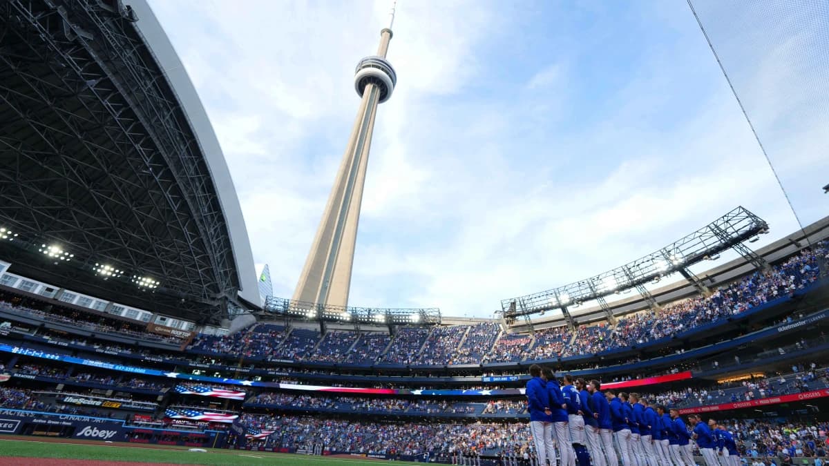 The Toronto Blue Jays stand during the USA national anthem before a game against the Miami Marlins at the Rogers Centre.