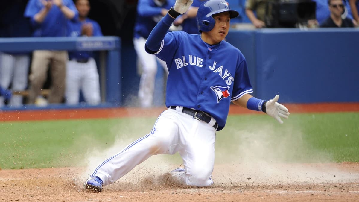 Toronto Blue Jays pinch hitter Munenori Kawasaki (66) scores against Houston Astros from an RBI single by short stop Jose Reyes (7) (not in picture) in the ninth inning at Rogers Centre. Toronto Blue Jays beat Houston Astros 7-6.
