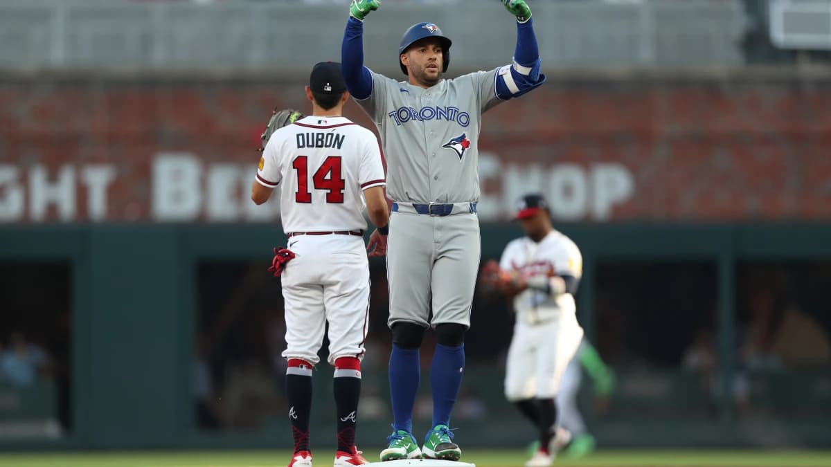 Toronto Blue Jays designated hitter George Springer (4) reacts after hitting a double against the Atlanta Braves in the first inning at Truist Park.
