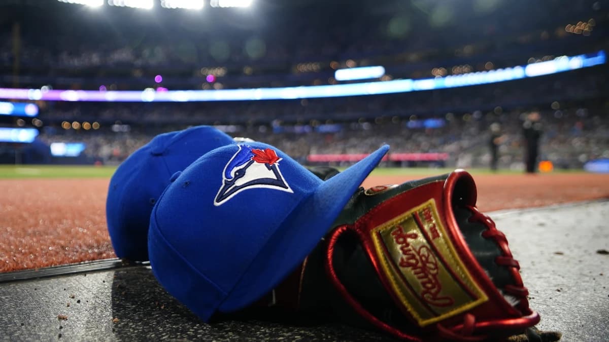 A pair of Toronto Blue Jays hats and glove in the dugout during a game against the Minnesota Twins at Rogers Centre.