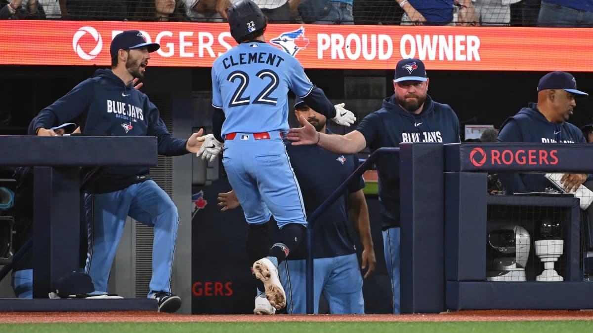 Toronto Blue Jays short stop Ernie Clement (22) celebrates a run with manager John Schneider (right) in the fourth inning against the New York Yankees at Rogers Centre.