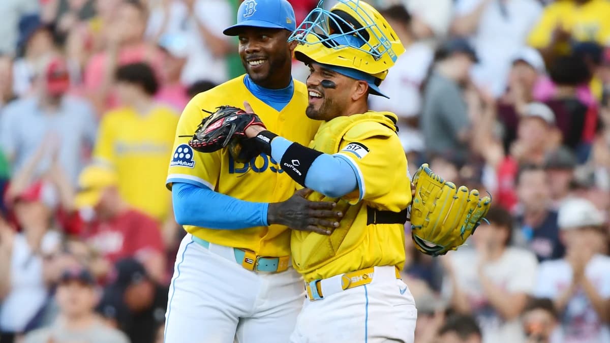 Boston Red Sox pitcher Aroldis Chapman (44) and catcher Carlos Narváez (75) smile after defeating the Texas Rangers at Fenway Park.
