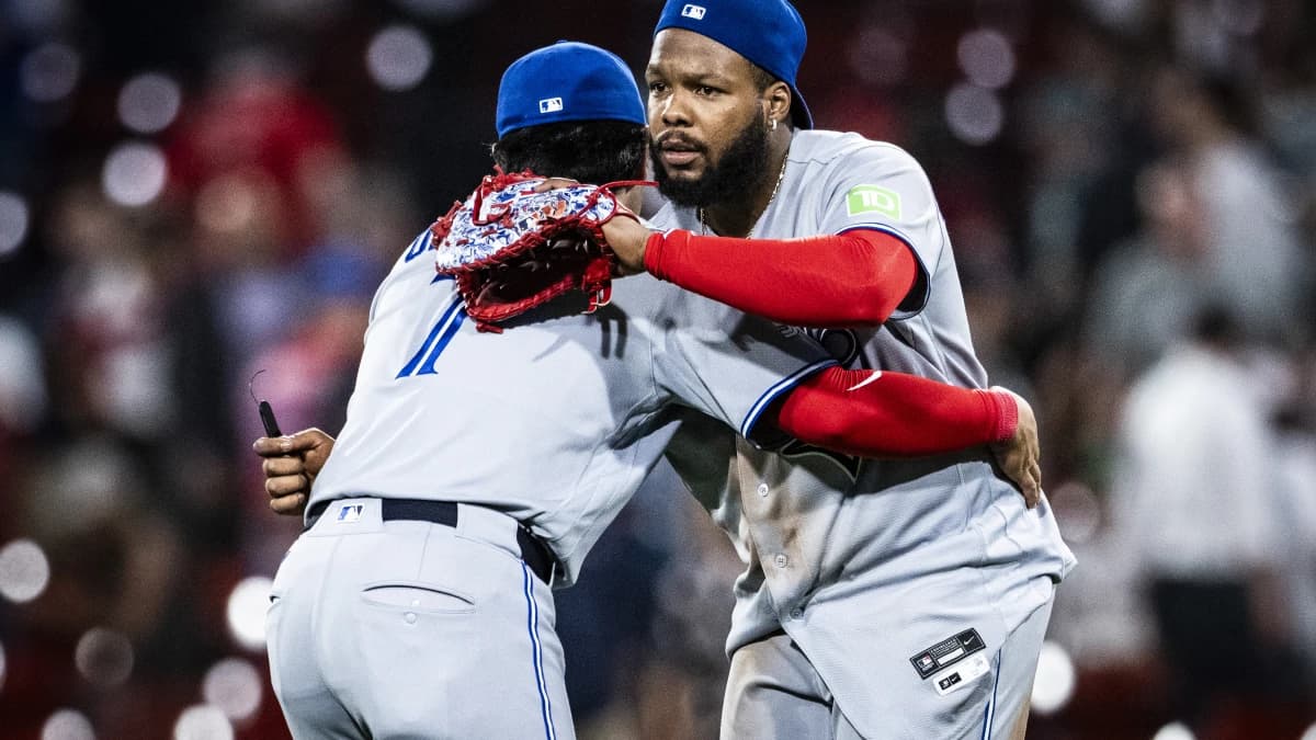 Toronto Blue Jays third baseman Kazuma Okamoto (7) and first baseman Vladimir Guerrero Jr. (27) embrace after their ninth inning win over the Boston Red Sox at Fenway Park.