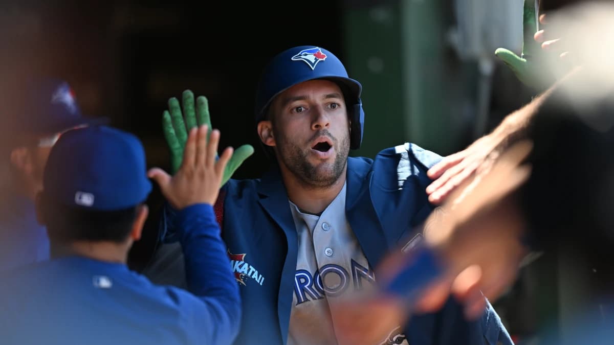 Toronto Blue Jays designated hitter George Springer (4) celebrates his a home run with teammates in the dugout against the Chicago Cubs during the sixth inning at Wrigley Field.