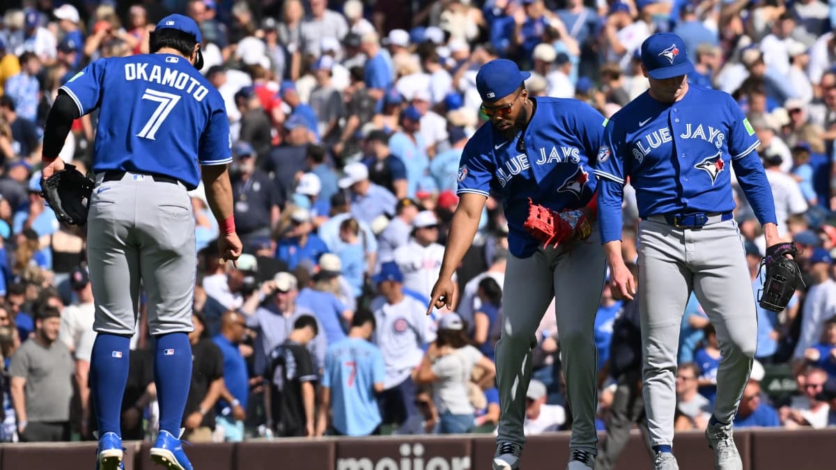 Toronto Blue Jays first baseman Vladimir Guerrero Jr. (27) and third baseman Kazuma Okamoto (7) celebrate after defeating the Chicago Cubs at Wrigley Field.