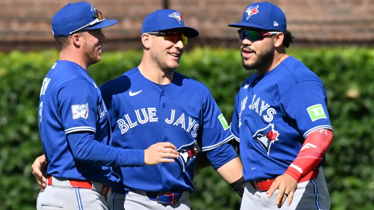 The Toronto Blue Jays celebrate after defeating the Chicago Cubs at Wrigley Field.
