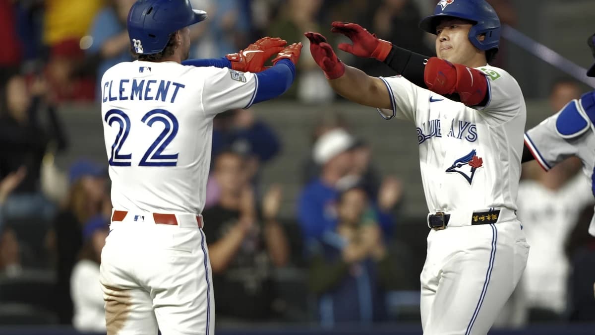 Toronto Blue Jays shortstop Ernie Clement (22) congratulates third baseman Kazuma Okamoto (7) on his two run home run against the Texas Rangers during the ninth inning at Rogers Centre