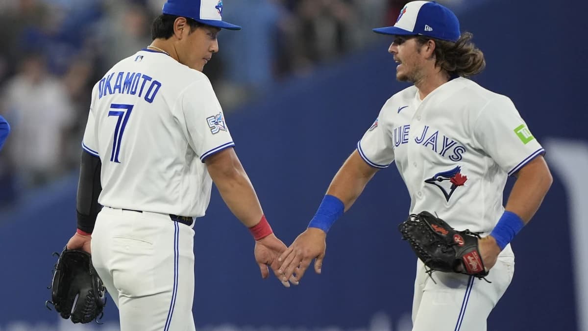 Toronto Blue Jays third baseman Kazuma Okamoto (7) and right fielder Addison Barger (47) celebrate a win over the Athletics at Rogers Centre.