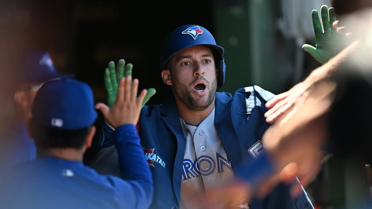 Toronto Blue Jays designated hitter George Springer (4) celebrates his a home run with teammates in the dugout against the Chicago Cubs during the sixth inning at Wrigley Field.
