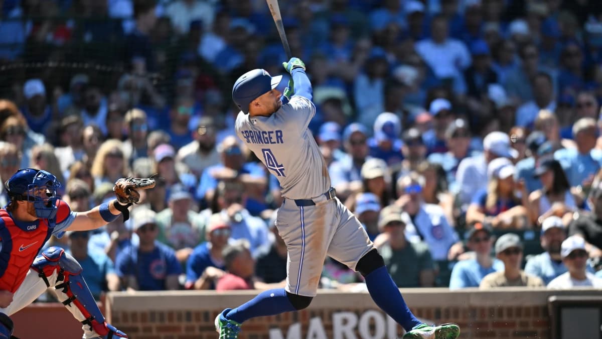 Toronto Blue Jays designated hitter George Springer (4) hits a home run against the Chicago Cubs during the sixth inning at Wrigley Field