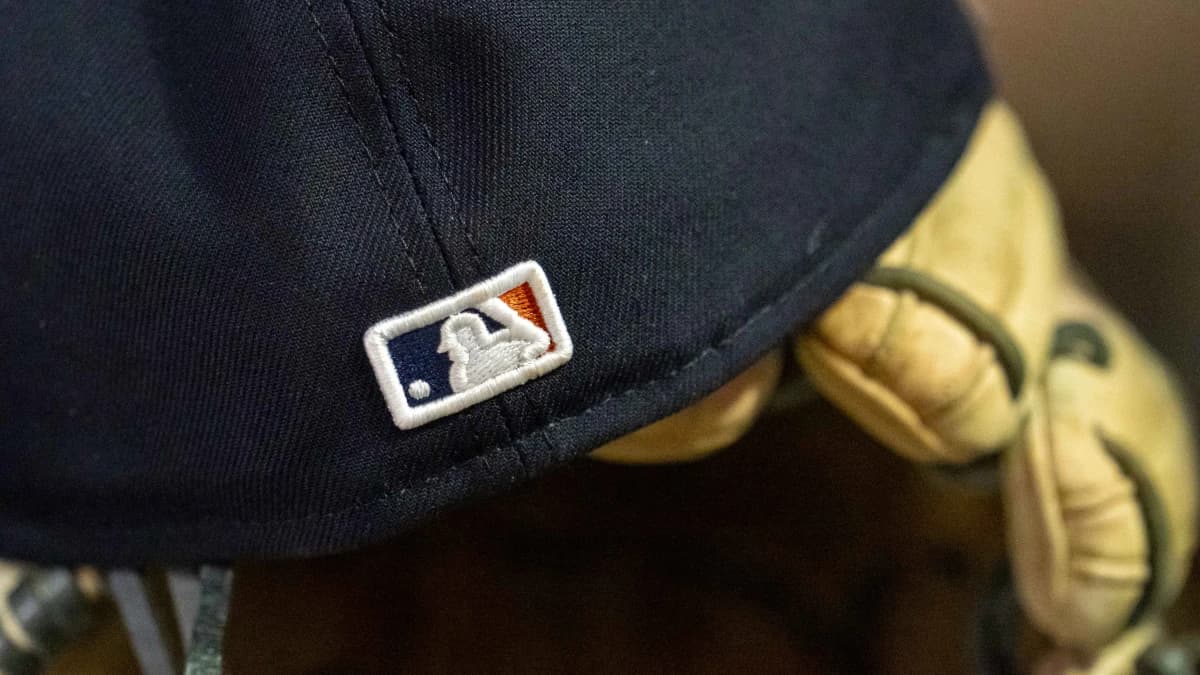 A general view of a Detroit Tigers hat with the Major League Baseball logo sitting in the dugout in a game against the Minnesota Twins at Target Field.