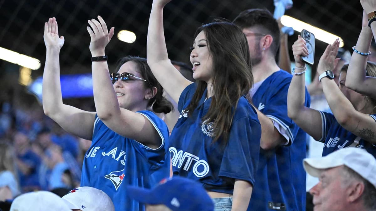 Toronto Blue Jays fans cheer for their team against the New York Mets in the ninth inning at Rogers Centre.