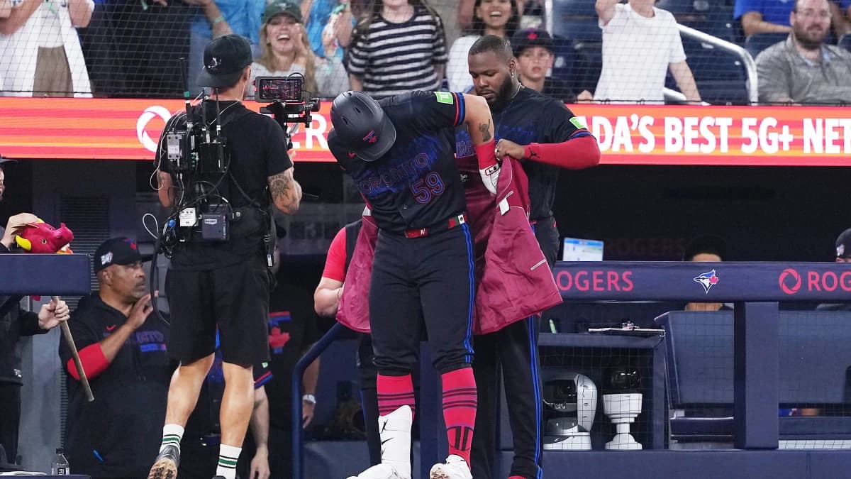 Toronto Blue Jays designated hitter Brandon Valenzuela (59) receives the home run jacket from first baseman Vladimir Guerrero Jr. (27) after hitting a home run against the Chicago White Sox during the sixth inning at Rogers Centre.
