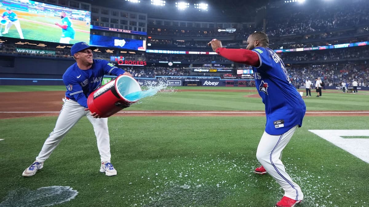 Toronto Blue Jays right fielder Myles Straw (3) attempts to pour the water bucket on first baseman Vladimir Guerrero Jr. (27) against the Chicago White Sox at the end of the ninth inning at Rogers Centre.