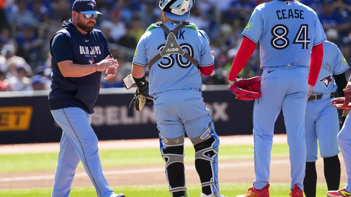 Toronto Blue Jays manager John Schneider (14) walks to the mound to relieve Toronto Blue Jays pitcher Dylan Cease (84) during the fifth inning at Rogers Centre.