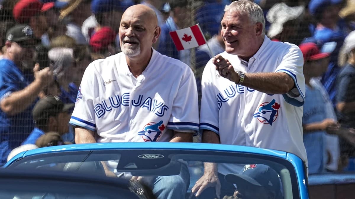 Former Toronto Blue Jays players Duane Ward (left) and Dave Stieb of the 1992 World Series champion team wave to fans during a presentation before a game against the Los Angeles Angels at Rogers Centre