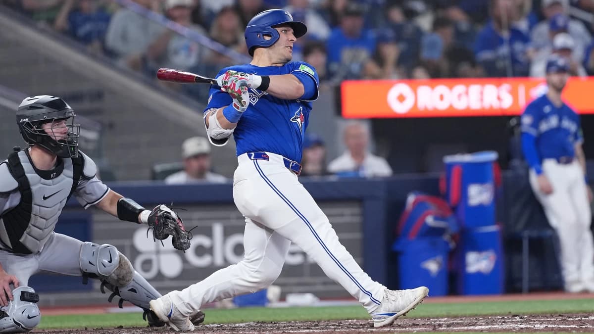 Toronto Blue Jays center fielder Daulton Varsho (5) hits a double against the Chicago White Sox during the sixth inning at Rogers Centre.