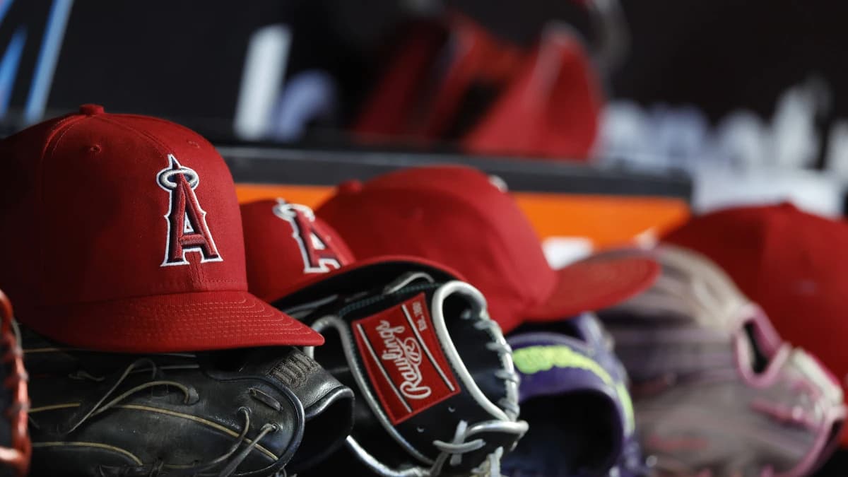 Los Angeles Angels hats and gloves sit in the dugout against the Miami Marlins during the fifth inning at loanDepot Park.