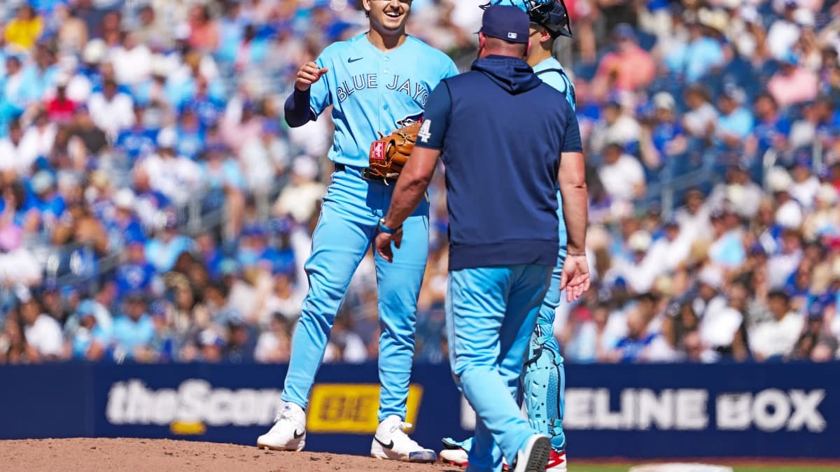 Toronto Blue Jays relief pitcher Ricky Tiedemann (33) is relieved by manager John Schneider (14) against the New York Yankees during the third inning at Rogers Centre.