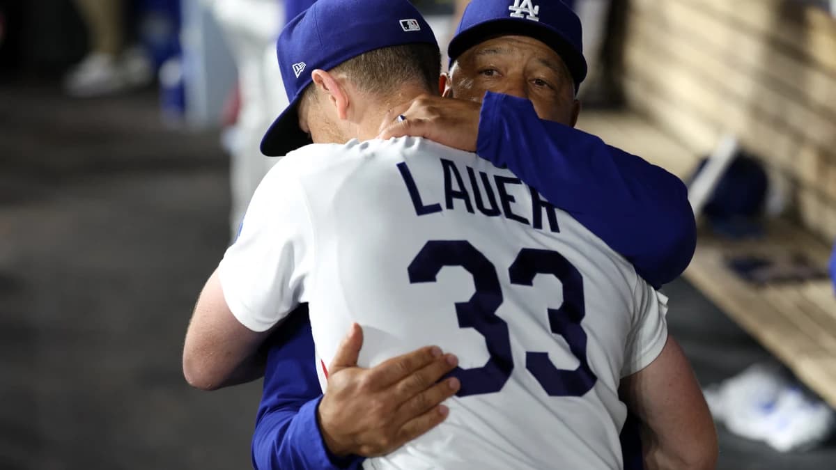 Los Angeles Dodgers pitcher Eric Lauer (33) hugs with manager Dave Roberts (30) after being removed from the game during the seventh inning against the Kansas City Royals at Dodger Stadium