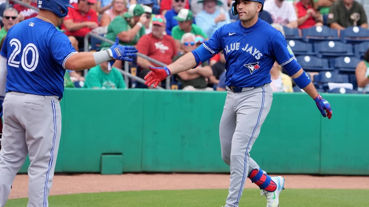 Toronto Blue Jays infielder Joey Votto (37) is congratulated after hitting a home run against the Philadelphia Phillies during the first inning at BayCare Ballpark.