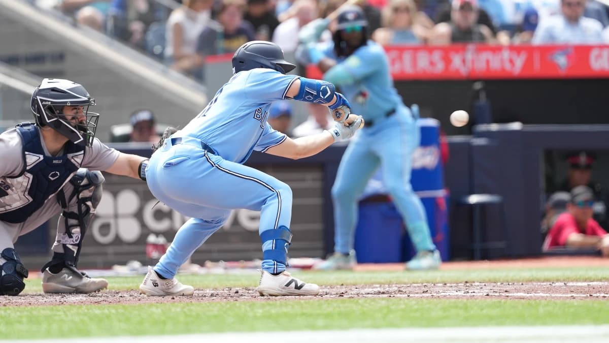 Toronto Blue Jays right fielder Brett Bateman (21) bunts the ball for a single against the New York Yankees during the sixth inning at Rogers Centre.