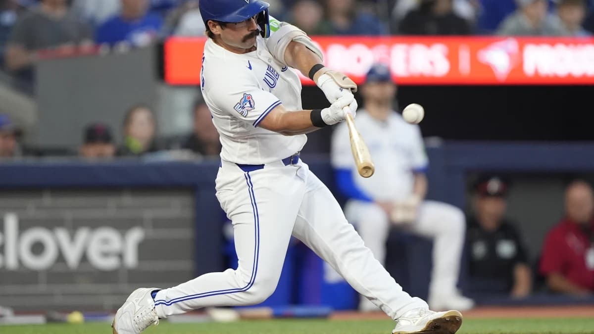 Toronto Blue Jays left fielder Davis Schneider (36) hits an RBI sacrifice fly against the Texas Rangers during the fifth inning at Rogers Centre.