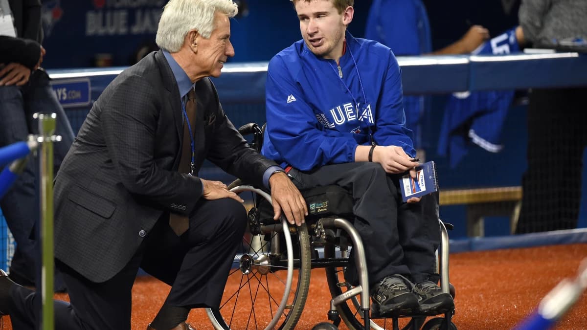 Toronto Blue Jays former catcher and now broadcaster Buck Martinez (left) chats with a fan prior to the Blue Jays game against Baltimore Orioles at Rogers Centre.