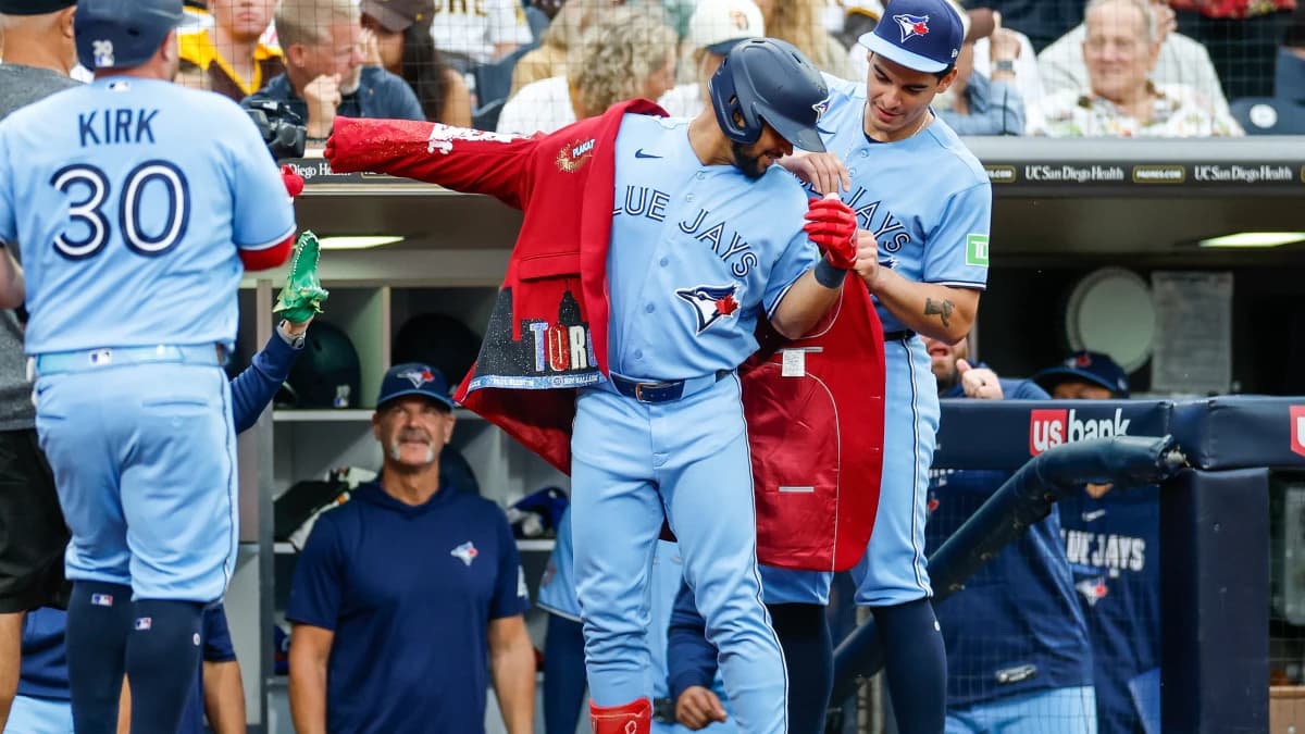 Toronto Blue Jays left fielder Jonatan Clase (8) celebrates in the dugout after hitting a two-run home run during the second inning against the San Diego Padres at Petco Park