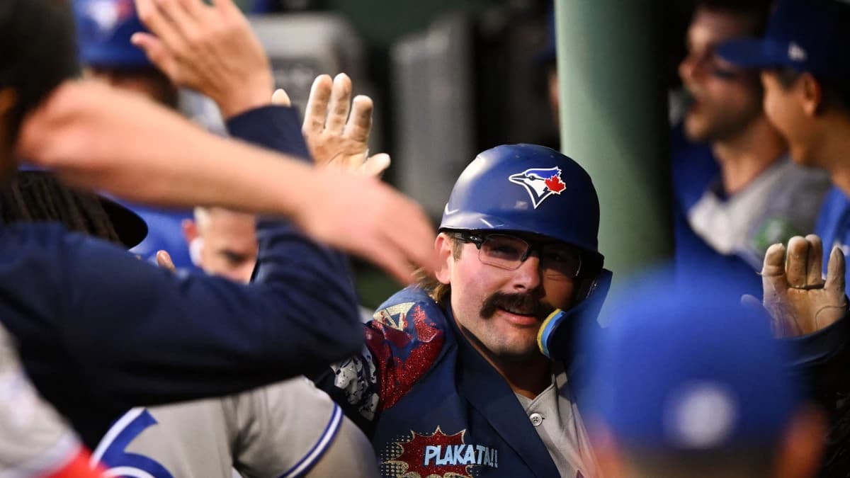 Toronto Blue Jays left fielder Davis Schneider (36) celebrates with his teammates after hitting a solo home run against the Boston Red Sox during the fifth inning at Fenway Park.