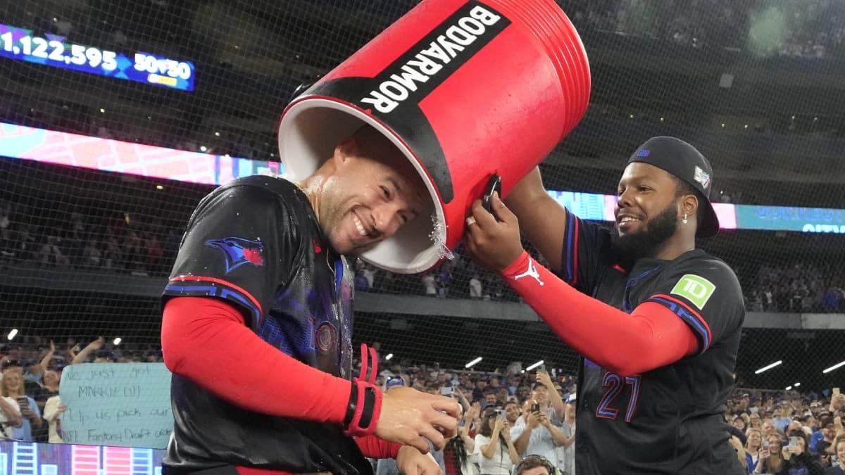 Toronto Blue Jays first baseman Vladimir Guerrero Jr. (27) puts an empty bucket of ice water over top of designated hitter George Springer (4) after a win over the Seattle Mariners at Rogers Centre.