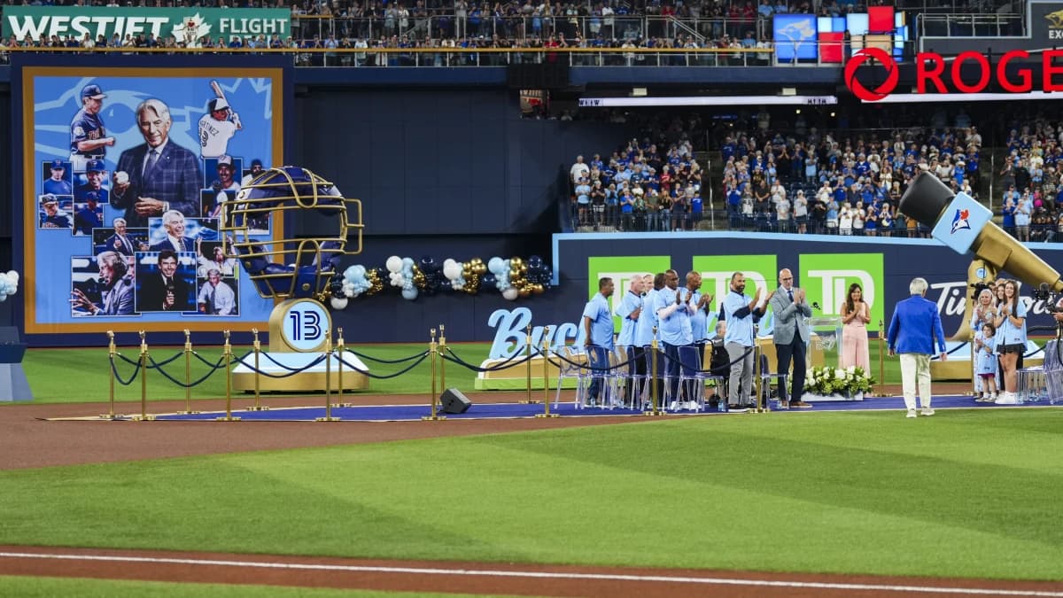 Buck Martinez walks to the podium during a pregame celebration before a game between the Toronto Blue Jays and Seattle Mariners at Rogers Centre