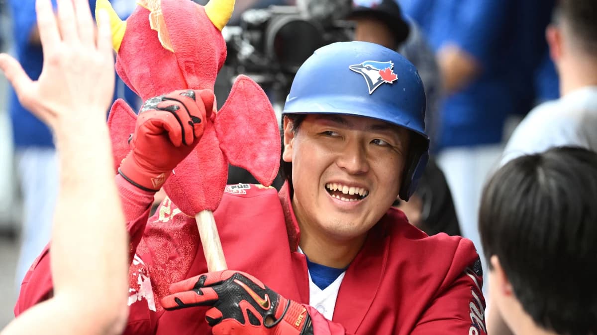 Toronto Blue Jays third baseman Kazuma Okamoto (7) celebrates with team mates in the dugout after hitting a solo home run against the Seattle Mariners in the sixth inning at Rogers Centre.