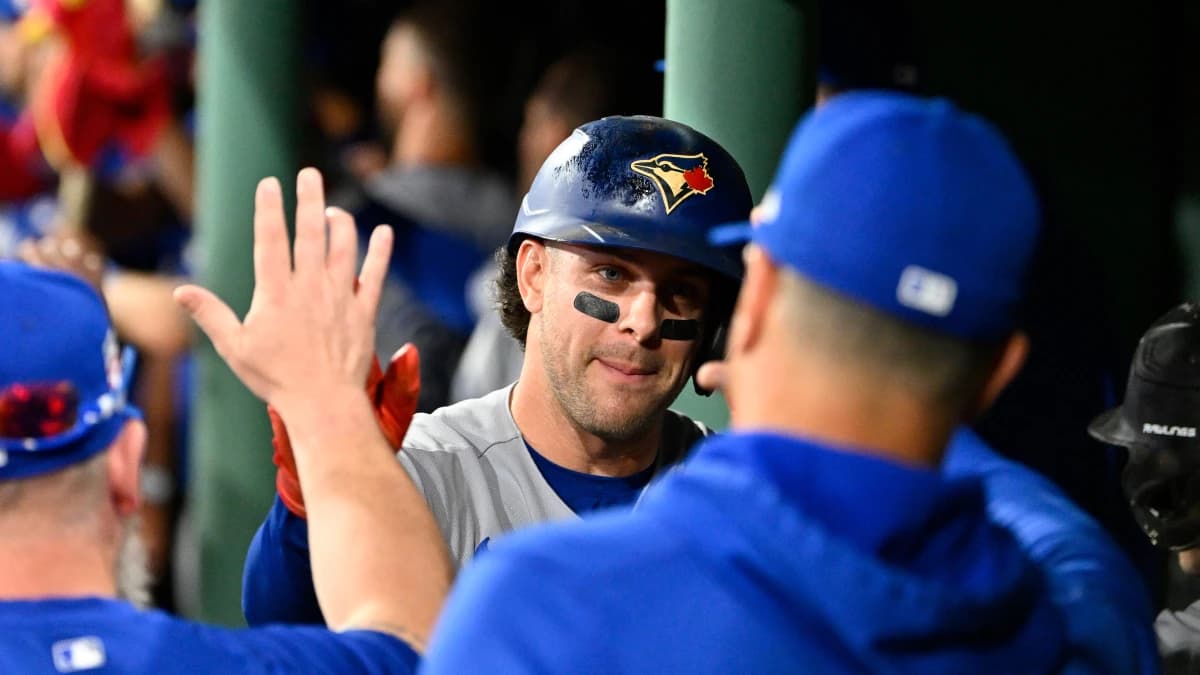 Toronto Blue Jays shortstop Ernie Clement (22) celebrates scoring a run off a home run by third baseman Kazuma Okamoto (7) during the seventh inning against the Boston Red Sox at Fenway Park