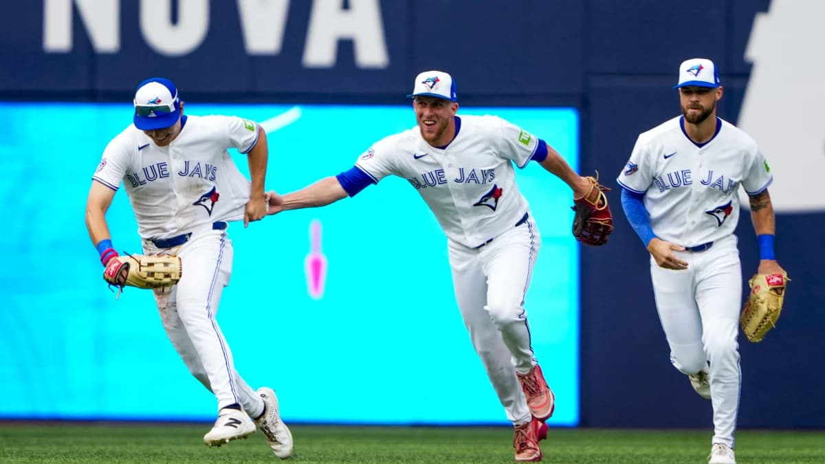 Toronto Blue Jays center fielder Myles Straw (3) celebrates with center fielder Brett Bateman (21) and right fielder Nathan Lukes (38) after defeating the Seattle Mariners at Rogers Centre