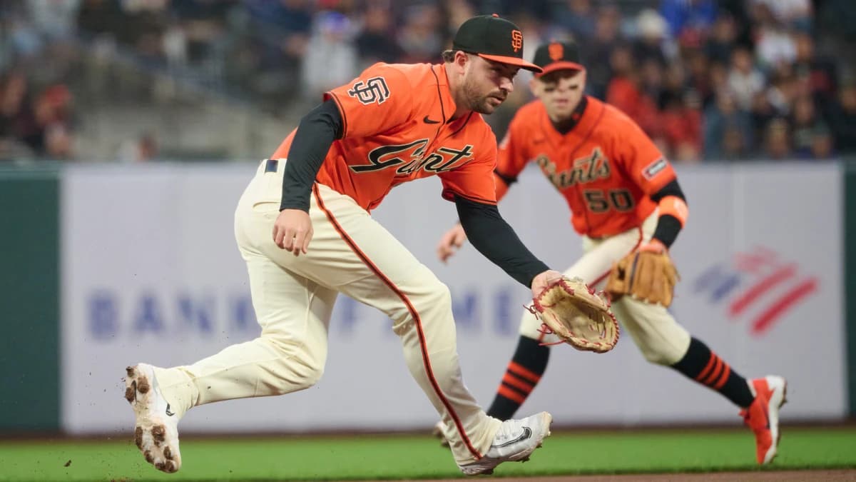 San Francisco Giants infielders Buddy Kennedy (41) and Christian Koss (50) move to field a ground ball hit by Colorado Rockies infielder Connor Norby (not pictured) during the second inning at Oracle Park.