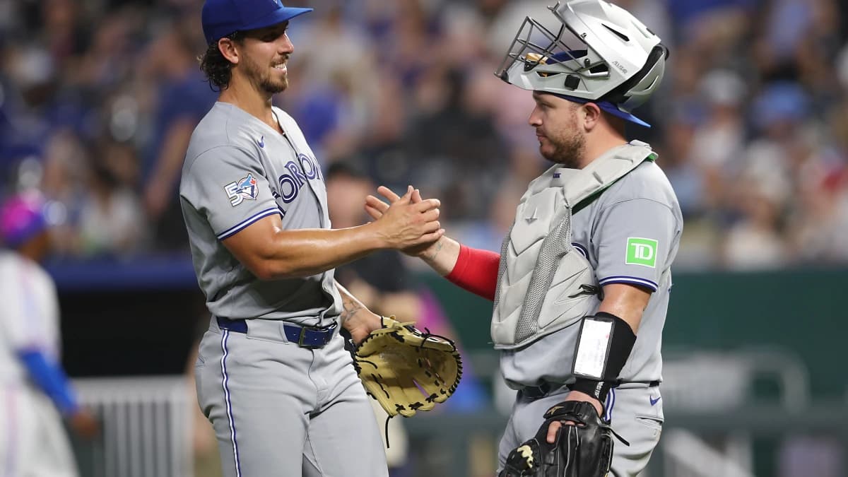 Toronto Blue Jays pitcher Michael Lorenzen (55) celebrates with catcher Alejandro Kirk (30) after defeating the Kansas City Royals at Kauffman Stadium