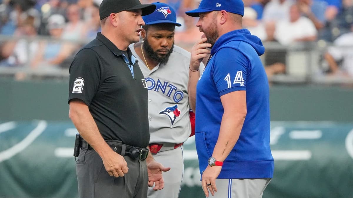 Toronto Blue Jays manager John Schneider (14) talks with umpire Dan Bellino (2) after a balk is called on starting pitcher Max Scherzer (31) (not pictured) against the Kansas City Royals during the first inning at Kauffman Stadium.