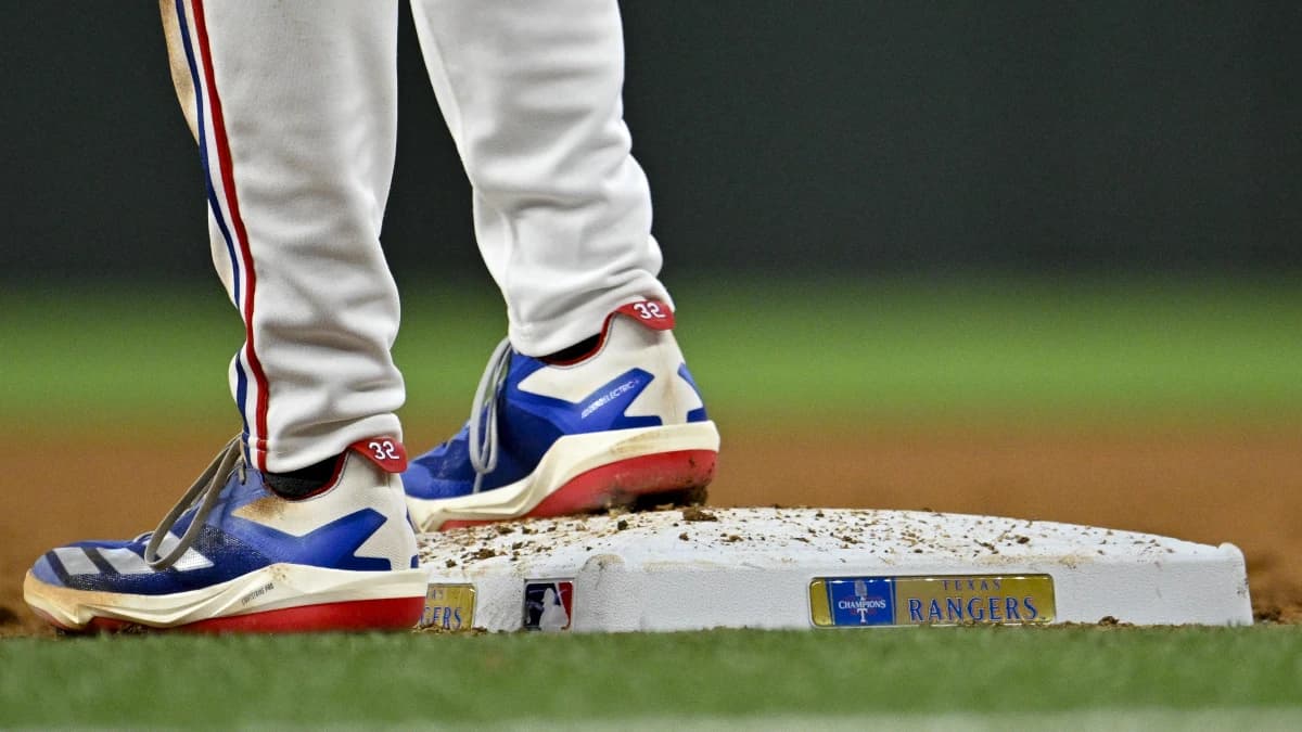 A view the shoes of Texas Rangers right fielder Evan Carter (32) and first base and the Rangers World Champions logo during the game against the Chicago Cubs at Globe Life Field