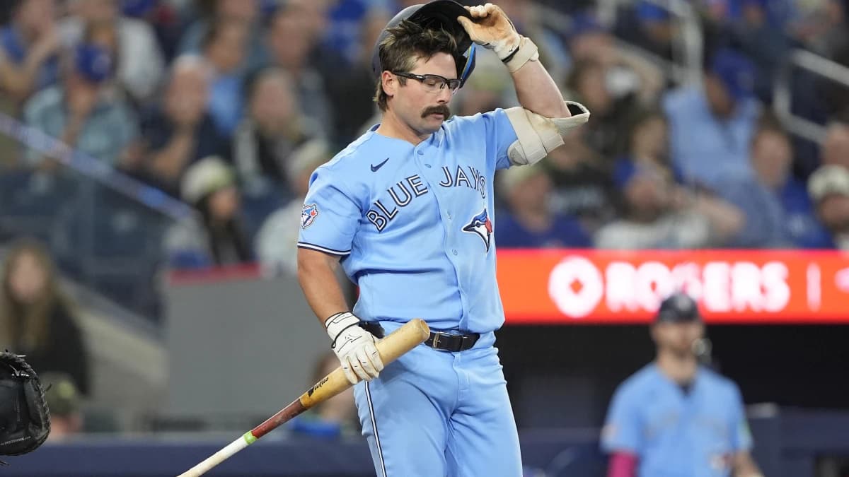 Toronto Blue Jays left fielder Davis Schneider (36) adjusts his helemt after taking a strike against the Houston Astros during the seventh inning at Rogers Centre.