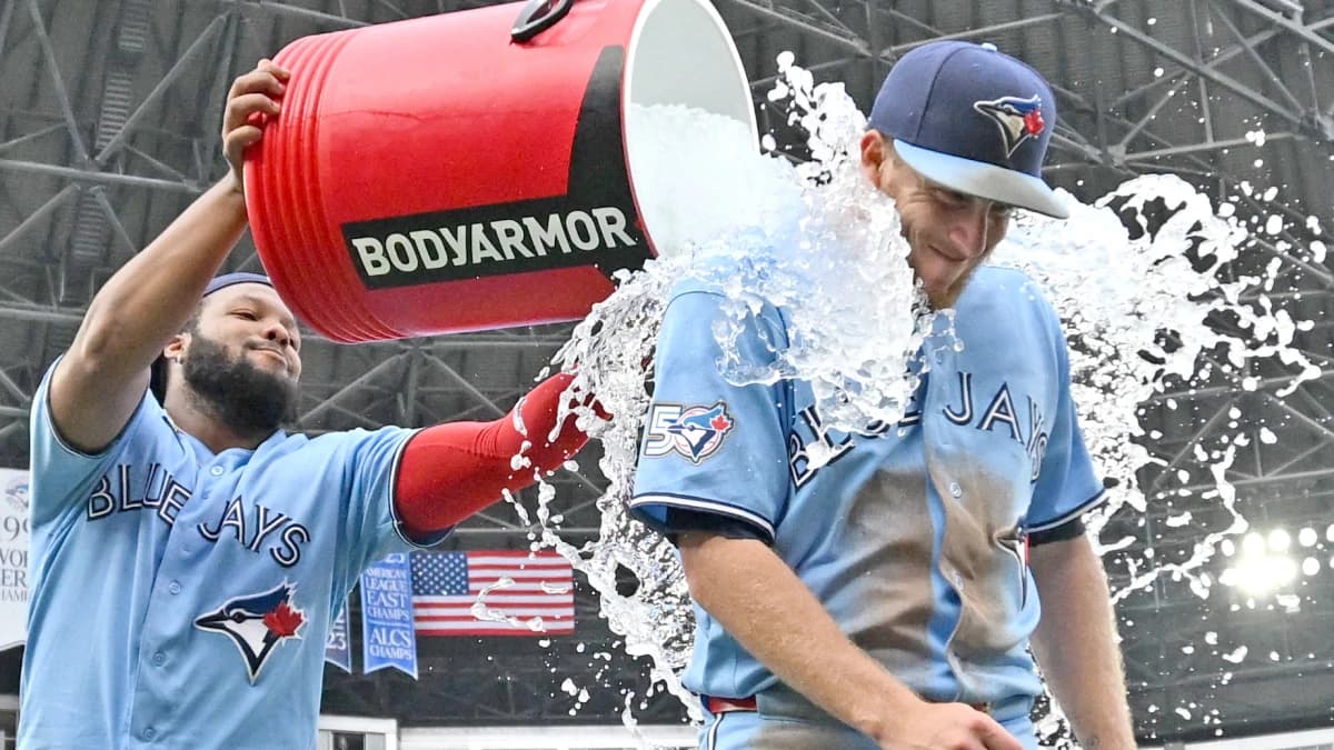 Toronto Blue Jays left fielder Myles Straw (3) gets doused with ice water by first baseman Vladimir Guerrero Jr. (27) as they celebrate a win over the Detroit Tigers at Rogers Centre